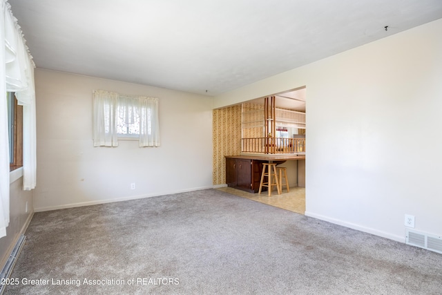 3316 Pickwick Pl, Lansing, MI 48917 - unfurnished living room featuring carpet floors and baseboards