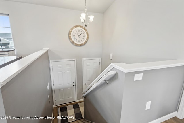 1123 Chesham Ln, Grand Ledge, MI 48837 - stairs featuring a chandelier