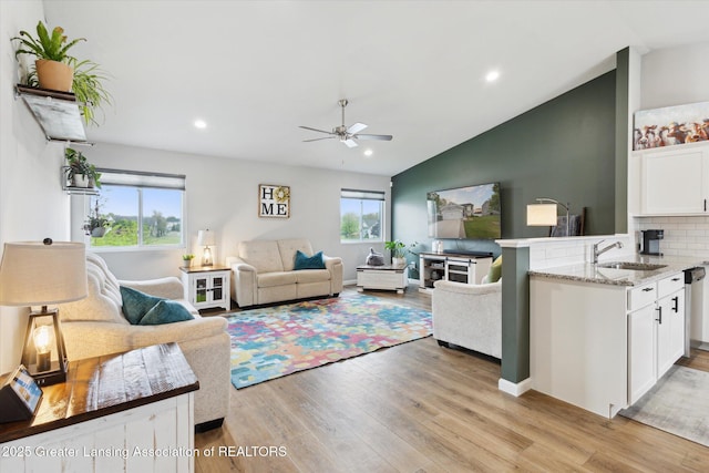 1123 Chesham Ln, Grand Ledge, MI 48837 - living area featuring light wood finished floors, a ceiling fan, lofted ceiling, and recessed lighting