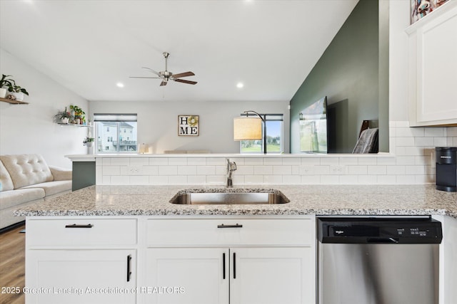 1123 Chesham Ln, Grand Ledge, MI 48837 - kitchen featuring dishwasher, a sink, open floor plan, ceiling fan, and light stone countertops