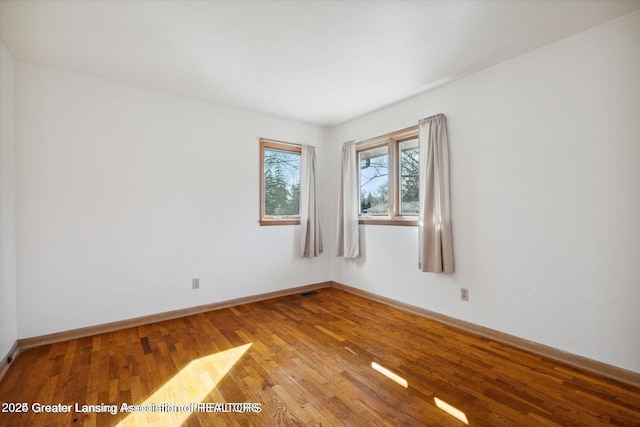 4794 Ardmore Ave, Okemos, MI 48864 - unfurnished room featuring wood finished floors and baseboards