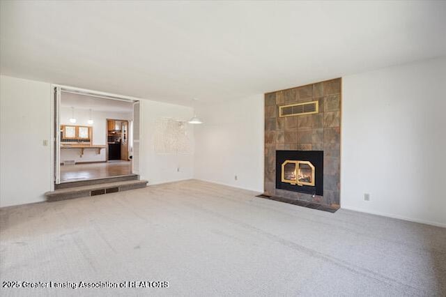4794 Ardmore Ave, Okemos, MI 48864 - unfurnished living room featuring carpet floors and a fireplace