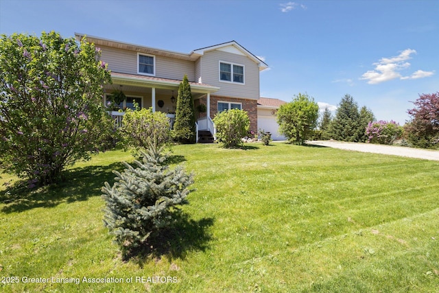 12898 Walker Rd, Leslie, MI 49251 - traditional-style house featuring an attached garage, brick siding, a front lawn, and a porch