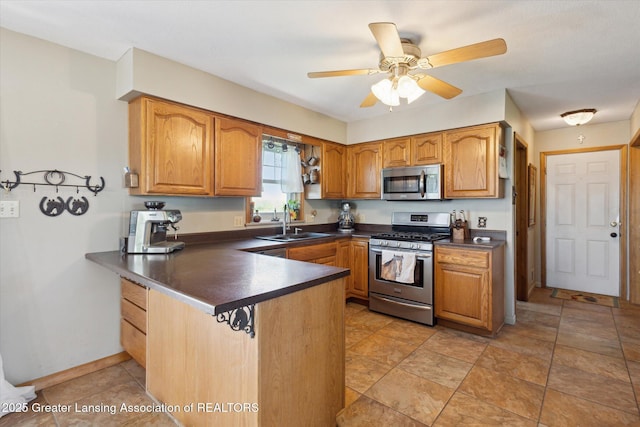 12898 Walker Rd, Leslie, MI 49251 - kitchen with appliances with stainless steel finishes, a sink, a peninsula, dark countertops, and brown cabinets