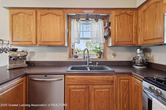 12898 Walker Rd, Leslie, MI 49251 - kitchen with appliances with stainless steel finishes, a sink, dark countertops, and brown cabinetry