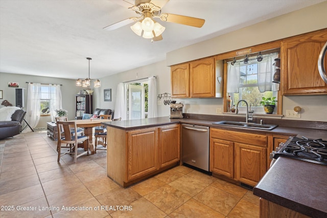 12898 Walker Rd, Leslie, MI 49251 - kitchen with appliances with stainless steel finishes, a sink, dark countertops, and a peninsula