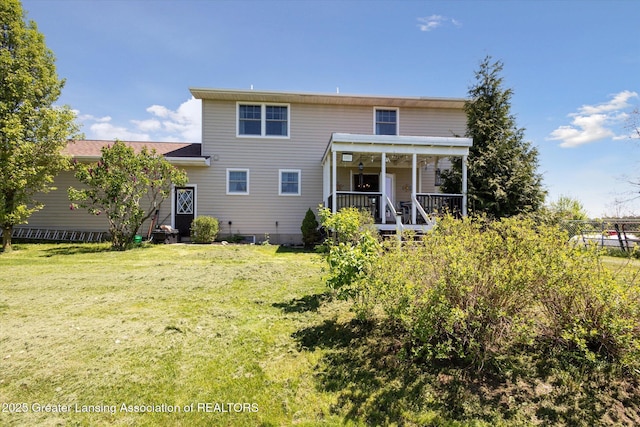 12898 Walker Rd, Leslie, MI 49251 - rear view of house featuring a lawn and a porch