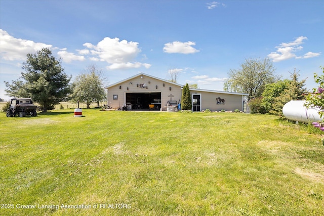 12898 Walker Rd, Leslie, MI 49251 - rear view of property with a yard, an outdoor structure, and a garage