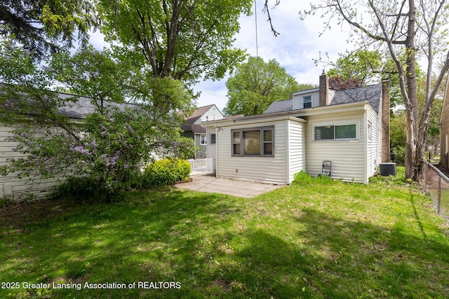 635 Division St, East Lansing, MI 48823 - rear view of property with a chimney, cooling unit, and a patio area