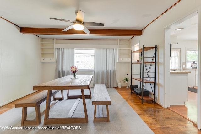 635 Division St, East Lansing, MI 48823 - dining area with beamed ceiling, light wood finished floors, a ceiling fan, and baseboards