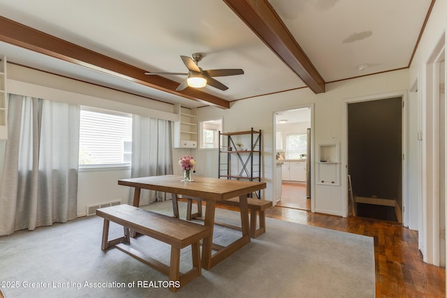 635 Division St, East Lansing, MI 48823 - dining area with beamed ceiling, ceiling fan, and dark wood-style floors