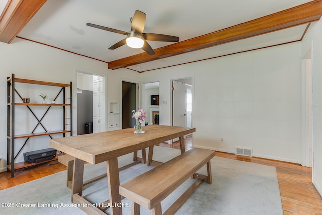 635 Division St, East Lansing, MI 48823 - dining space with a ceiling fan, light wood finished floors, and beam ceiling