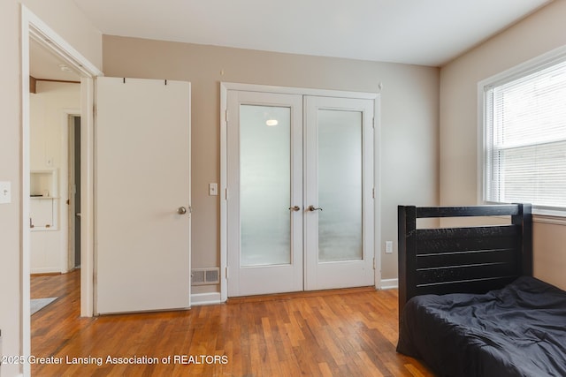635 Division St, East Lansing, MI 48823 - bedroom featuring french doors, hardwood / wood-style floors, and a closet