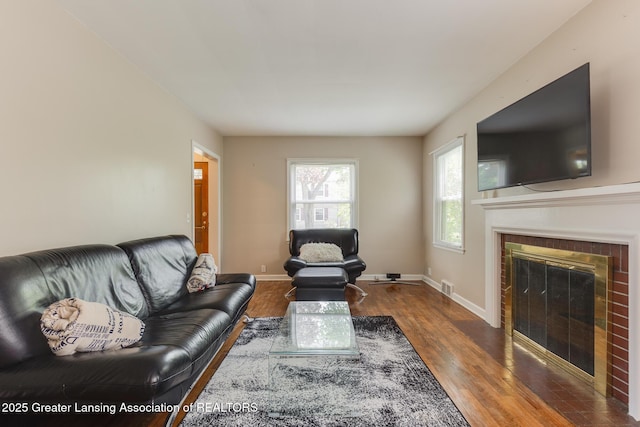 635 Division St, East Lansing, MI 48823 - living area featuring wood finished floors, a fireplace, and baseboards