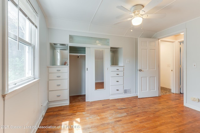 635 Division St, East Lansing, MI 48823 - unfurnished bedroom featuring a closet, light wood finished floors, and ceiling fan