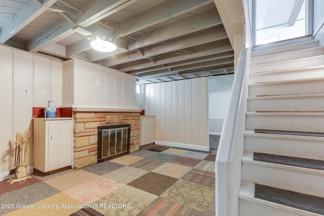 635 Division St, East Lansing, MI 48823 - basement featuring stairs, a stone fireplace, and baseboards