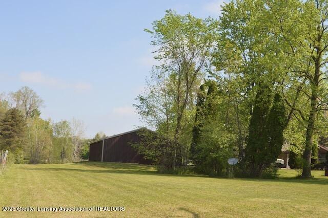 6157 W Stoll Rd, Lansing, MI 48906 - view of green lawn with a pole building and an outdoor structure