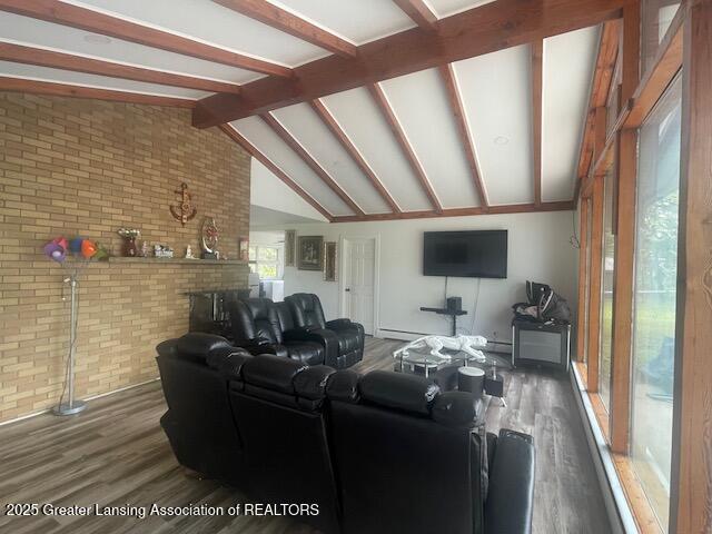 6157 W Stoll Rd, Lansing, MI 48906 - living room with brick wall and wood finished floors