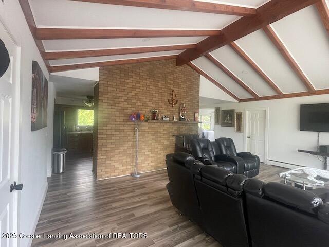 6157 W Stoll Rd, Lansing, MI 48906 - living area featuring wood finished floors, brick wall, healthy amount of natural light, and a ceiling fan