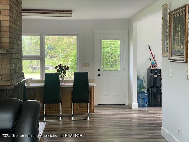 6157 W Stoll Rd, Lansing, MI 48906 - dining space with plenty of natural light, wood finished floors, and baseboards