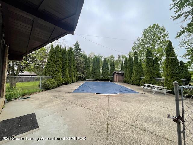 6157 W Stoll Rd, Lansing, MI 48906 - view of pool with a patio and an outbuilding
