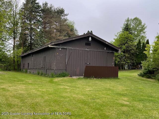6157 W Stoll Rd, Lansing, MI 48906 - view of property exterior with a yard and an outbuilding