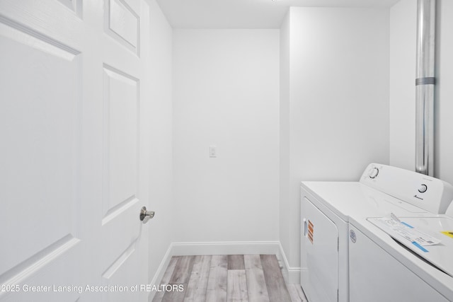 2107 Reo Rd, Lansing, MI 48910 - clothes washing area with separate washer and dryer, light wood finished floors, and baseboards