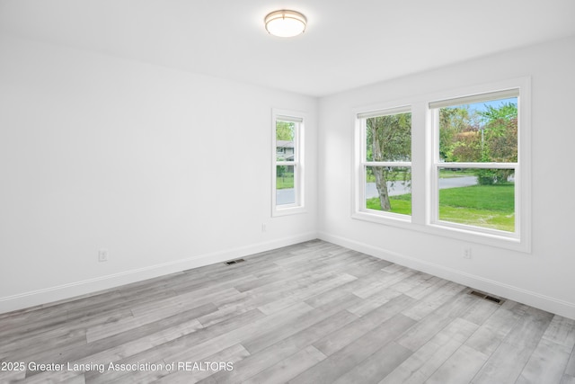 2107 Reo Rd, Lansing, MI 48910 - empty room with baseboards and light wood finished floors