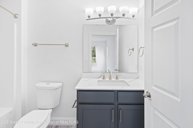 2107 Reo Rd, Lansing, MI 48910 - full bathroom with toilet, vanity, a shower, and baseboards