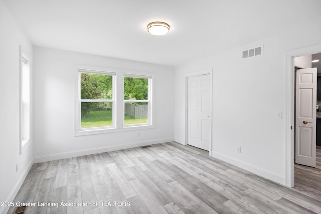 2107 Reo Rd, Lansing, MI 48910 - empty room with light wood-style flooring and baseboards
