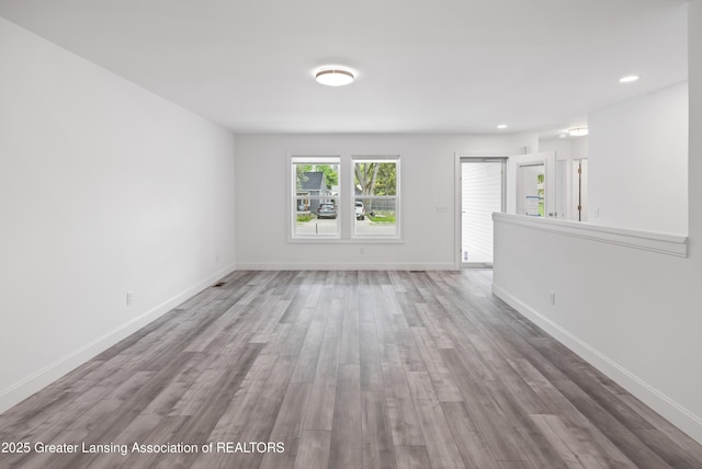 2107 Reo Rd, Lansing, MI 48910 - spare room featuring wood finished floors, baseboards, and recessed lighting