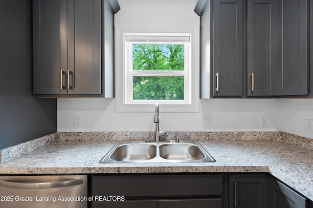 2107 Reo Rd, Lansing, MI 48910 - kitchen with a sink, dishwasher, light countertops, and gray cabinetry