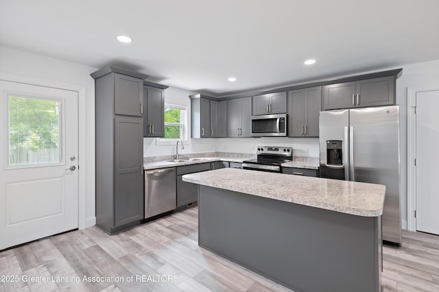 2107 Reo Rd, Lansing, MI 48910 - kitchen featuring appliances with stainless steel finishes, a sink, light countertops, gray cabinetry, and recessed lighting