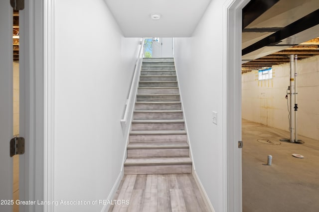 2107 Reo Rd, Lansing, MI 48910 - staircase featuring healthy amount of natural light and wood finished floors