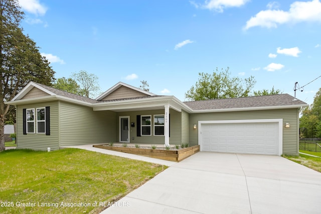 2107 Reo Rd, Lansing, MI 48910 - ranch-style house with an attached garage, a porch, driveway, a front lawn, and a shingled roof