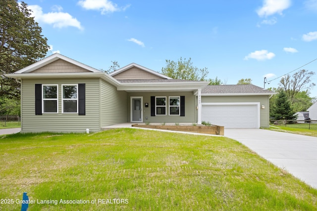 2107 Reo Rd, Lansing, MI 48910 - view of front of property with driveway, a garage, a front yard, and a porch