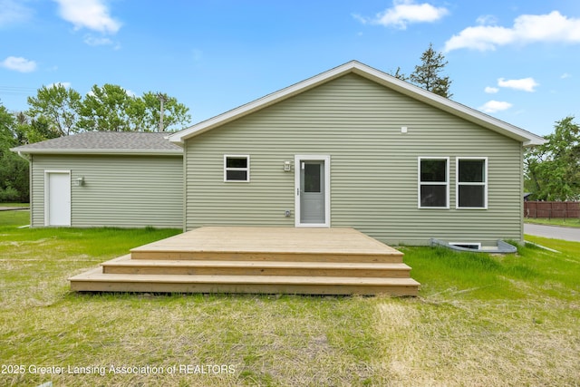 2107 Reo Rd, Lansing, MI 48910 - back of house featuring a yard, a wooden deck, and a shingled roof