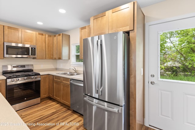 4205 Glenburne Blvd, Lansing, MI 48911 - kitchen featuring appliances with stainless steel finishes, a sink, light countertops, light wood-style floors, and recessed lighting