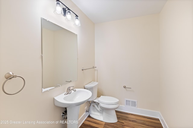 4205 Glenburne Blvd, Lansing, MI 48911 - bathroom with wood finished floors, toilet, and baseboards
