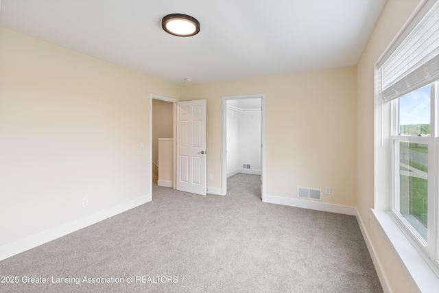 4205 Glenburne Blvd, Lansing, MI 48911 - unfurnished bedroom featuring carpet, multiple windows, and baseboards