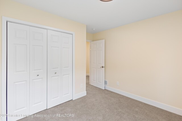 4205 Glenburne Blvd, Lansing, MI 48911 - unfurnished bedroom with carpet, a closet, and baseboards