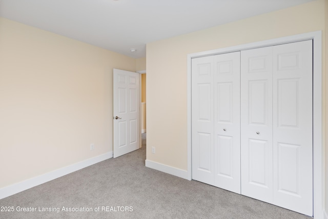 4205 Glenburne Blvd, Lansing, MI 48911 - unfurnished bedroom featuring carpet, a closet, and baseboards