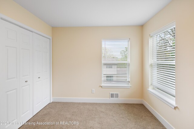 4205 Glenburne Blvd, Lansing, MI 48911 - unfurnished bedroom featuring carpet flooring, a closet, and baseboards