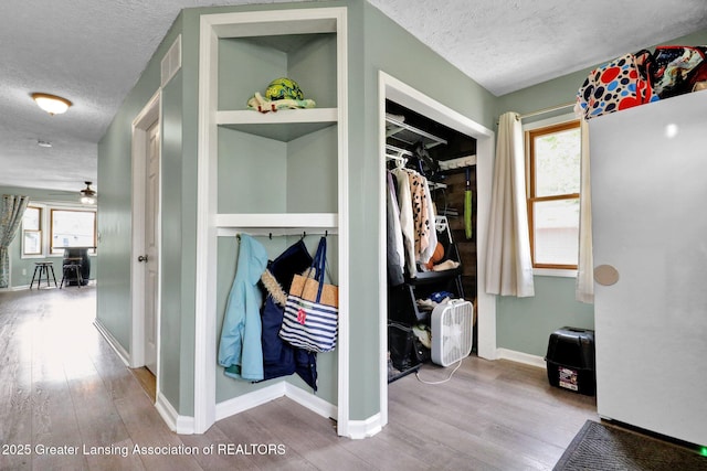 513 E Grand River Rd, Laingsburg, MI 48848 - mudroom featuring a textured ceiling, wood finished floors, a ceiling fan, and baseboards