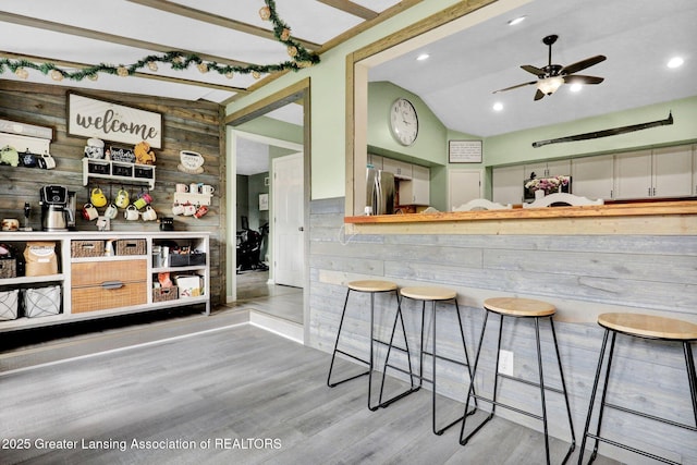 513 E Grand River Rd, Laingsburg, MI 48848 - bar area with freestanding refrigerator, wood finished floors, ceiling fan, vaulted ceiling, and recessed lighting