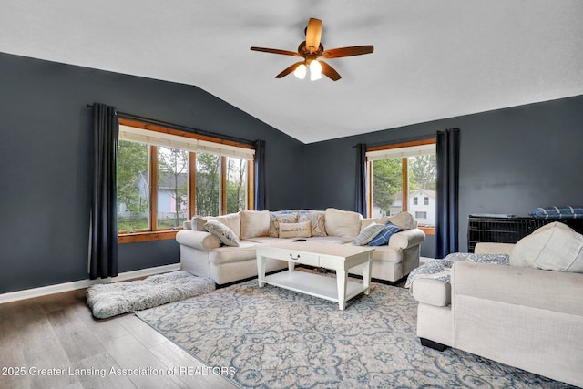 513 E Grand River Rd, Laingsburg, MI 48848 - living area with lofted ceiling, ceiling fan, wood finished floors, and baseboards