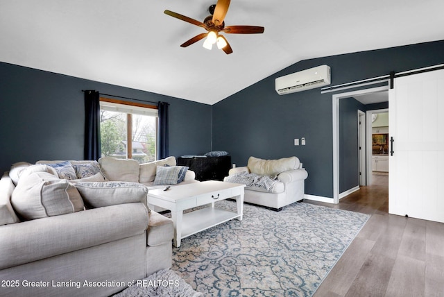 513 E Grand River Rd, Laingsburg, MI 48848 - living room featuring a wall mounted air conditioner, ceiling fan, lofted ceiling, wood finished floors, and a barn door