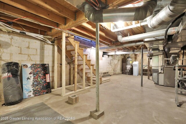 513 E Grand River Rd, Laingsburg, MI 48848 - unfinished below grade area featuring gas water heater, stairway, and heating unit