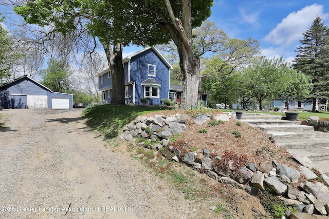 513 E Grand River Rd, Laingsburg, MI 48848 - view of front facade with a garage and an outdoor structure