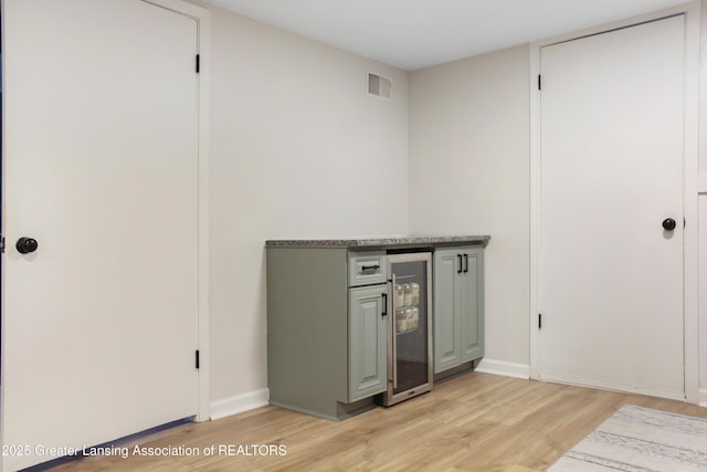 14275 Webster Rd, Bath, MI 48808 - unfurnished office with light wood-style flooring, beverage cooler, and baseboards